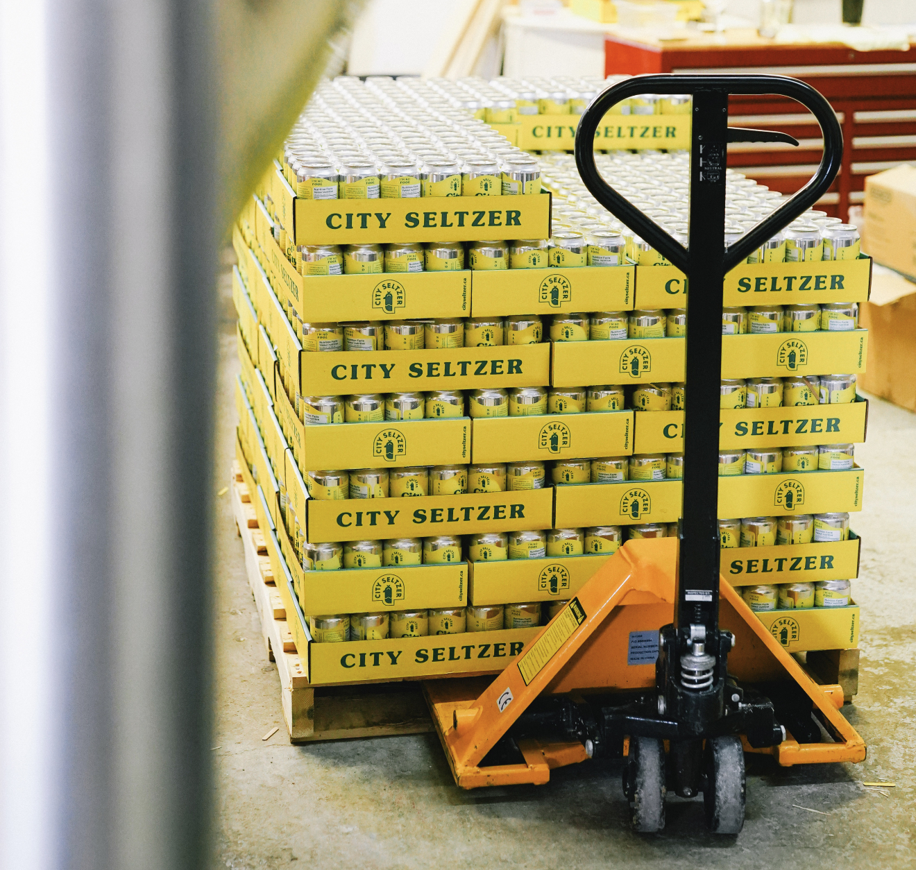 A full palette of lemon-yellow City Seltzer Citrus cases, ready to roll out the door.